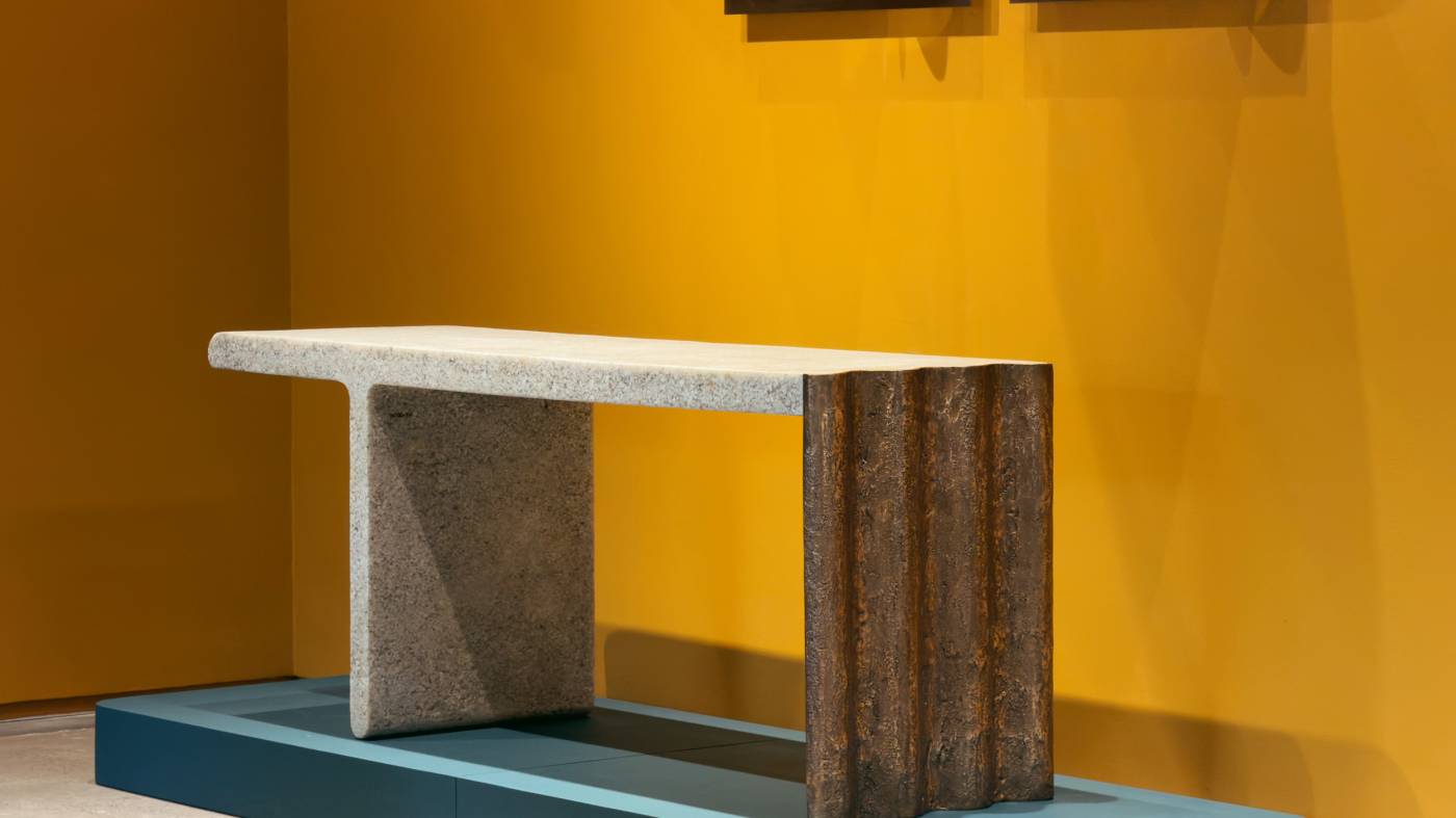 Flucta console with textured surfaces and contrasting sculptural supports at Firma Casa