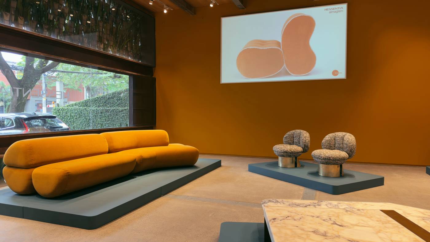 HESSENTIA furniture display with curved sofa and upholstered chairs at Firma Casa in São Paulo